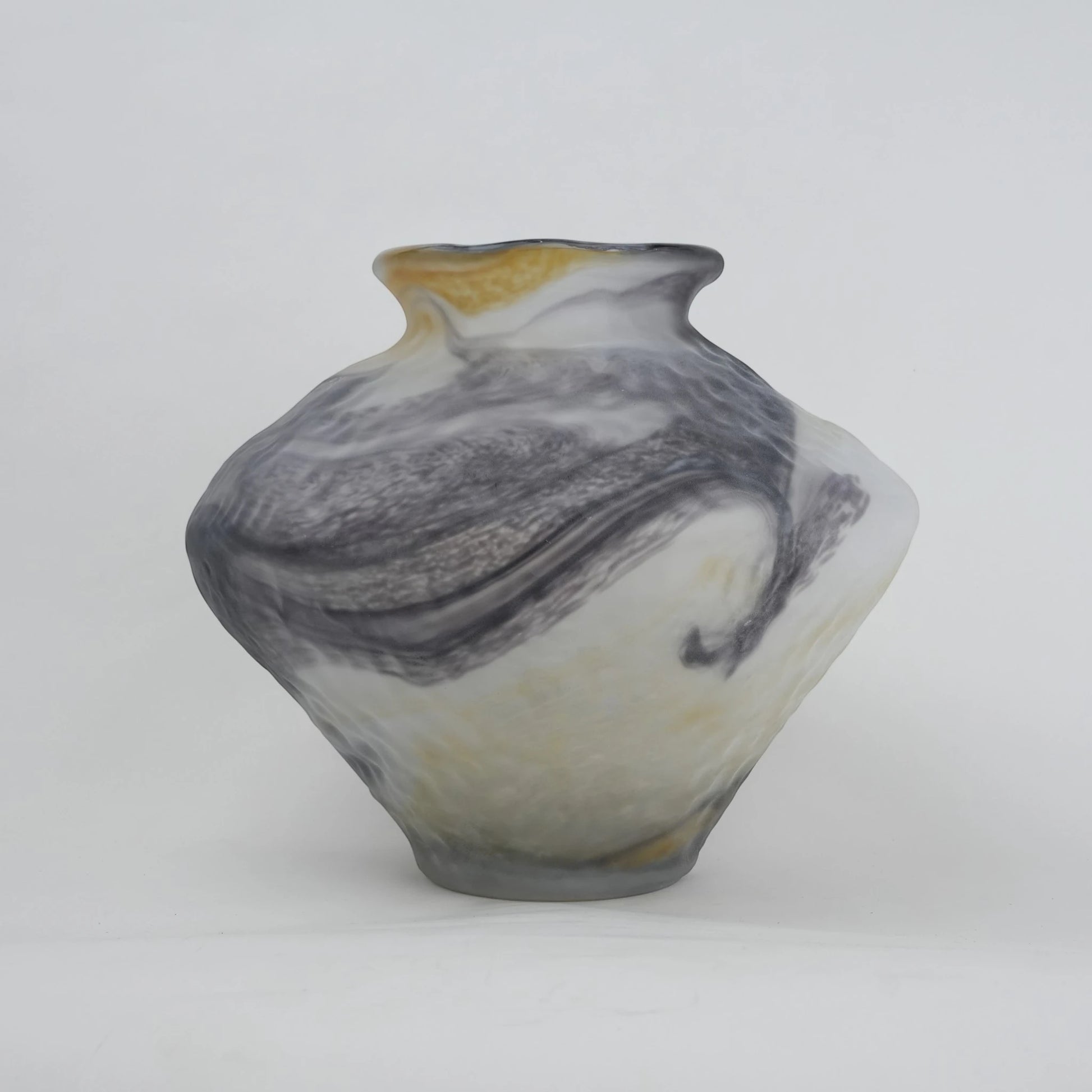 White marble art glass vase with organic pattern and wide asymmetrical form.