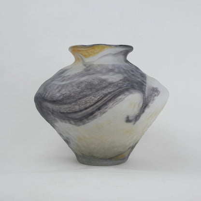White marble art glass vase with organic pattern and wide asymmetrical form.