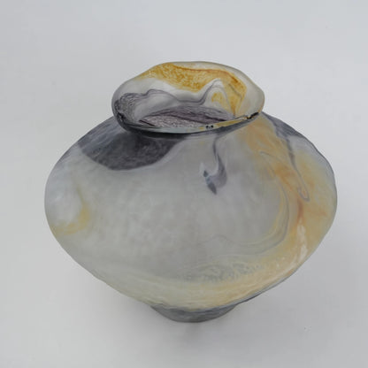 White marble art glass vase with organic pattern and wide asymmetrical form.