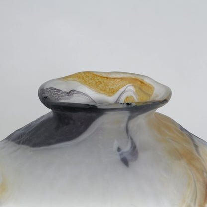 White marble art glass vase with organic pattern and wide asymmetrical form.