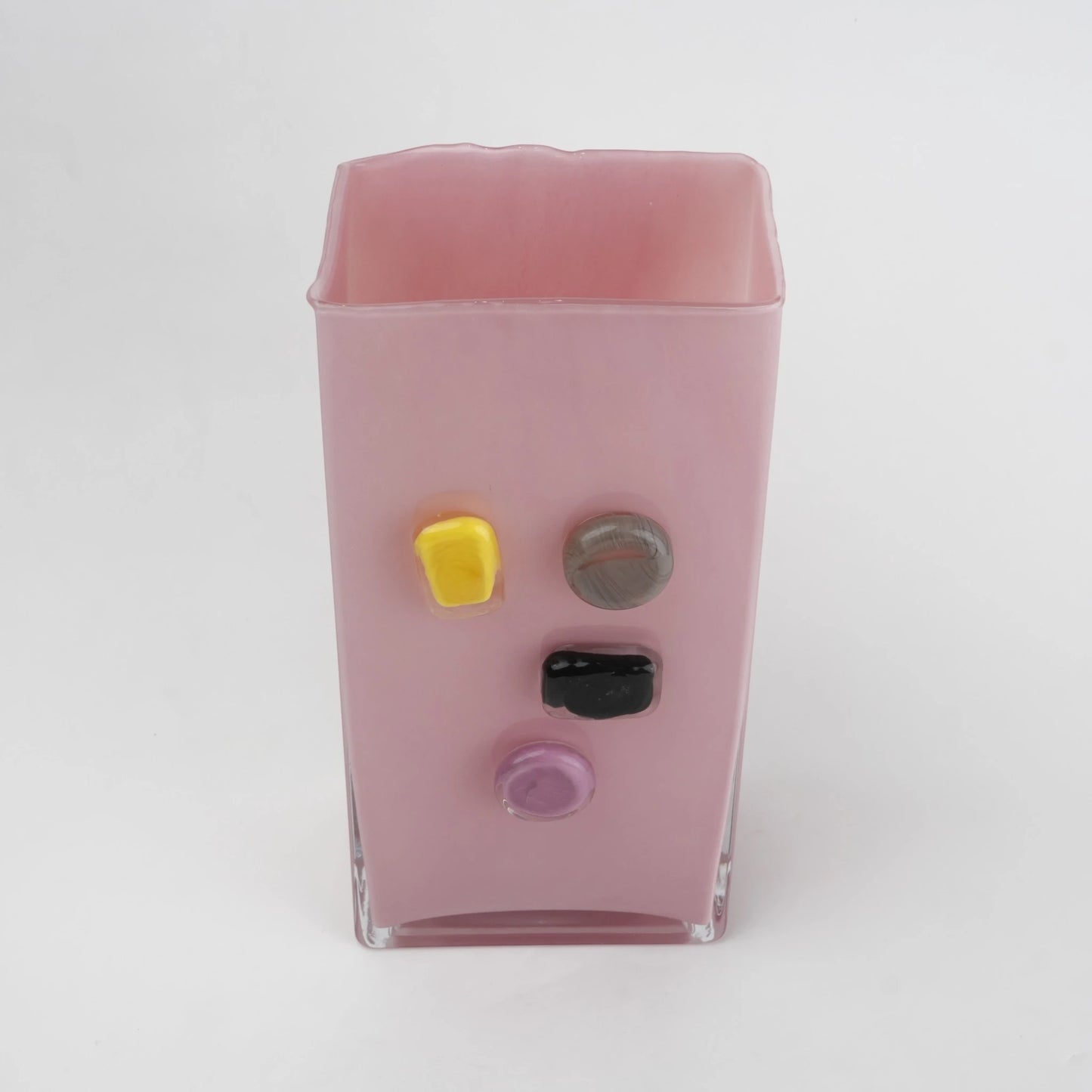 Pink art glass vase with embedded multicolor accents and wide rectangular form.