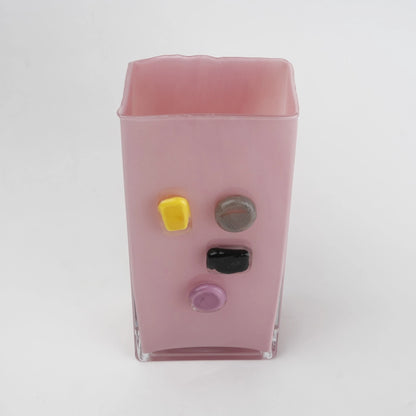 Pink art glass vase with embedded multicolor accents and wide rectangular form.