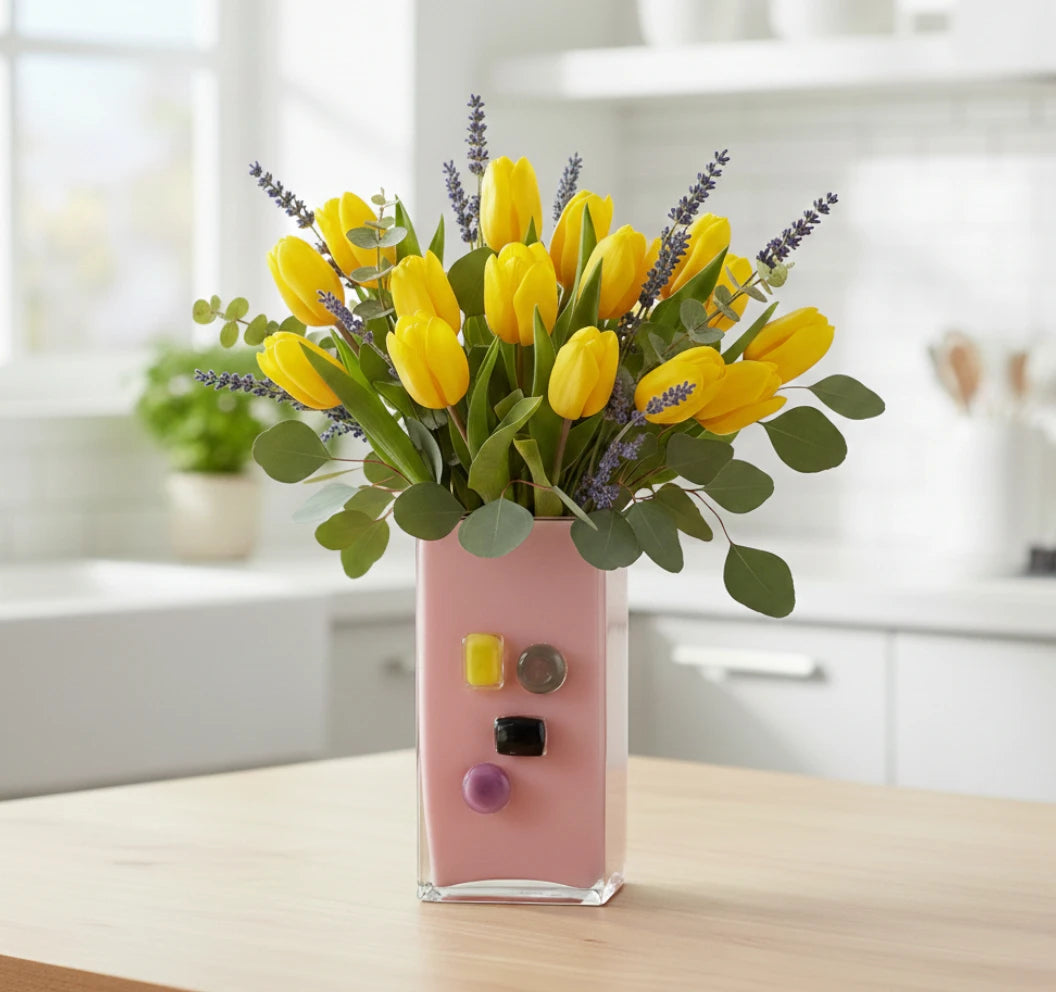 Pink art glass vase with embedded multicolor accents and wide rectangular form.