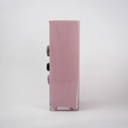 Pink art glass vase with embedded multicolor accents and wide rectangular form.