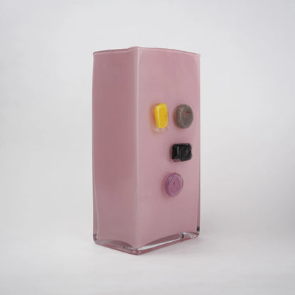 Pink art glass vase with embedded multicolor accents and wide rectangular form.