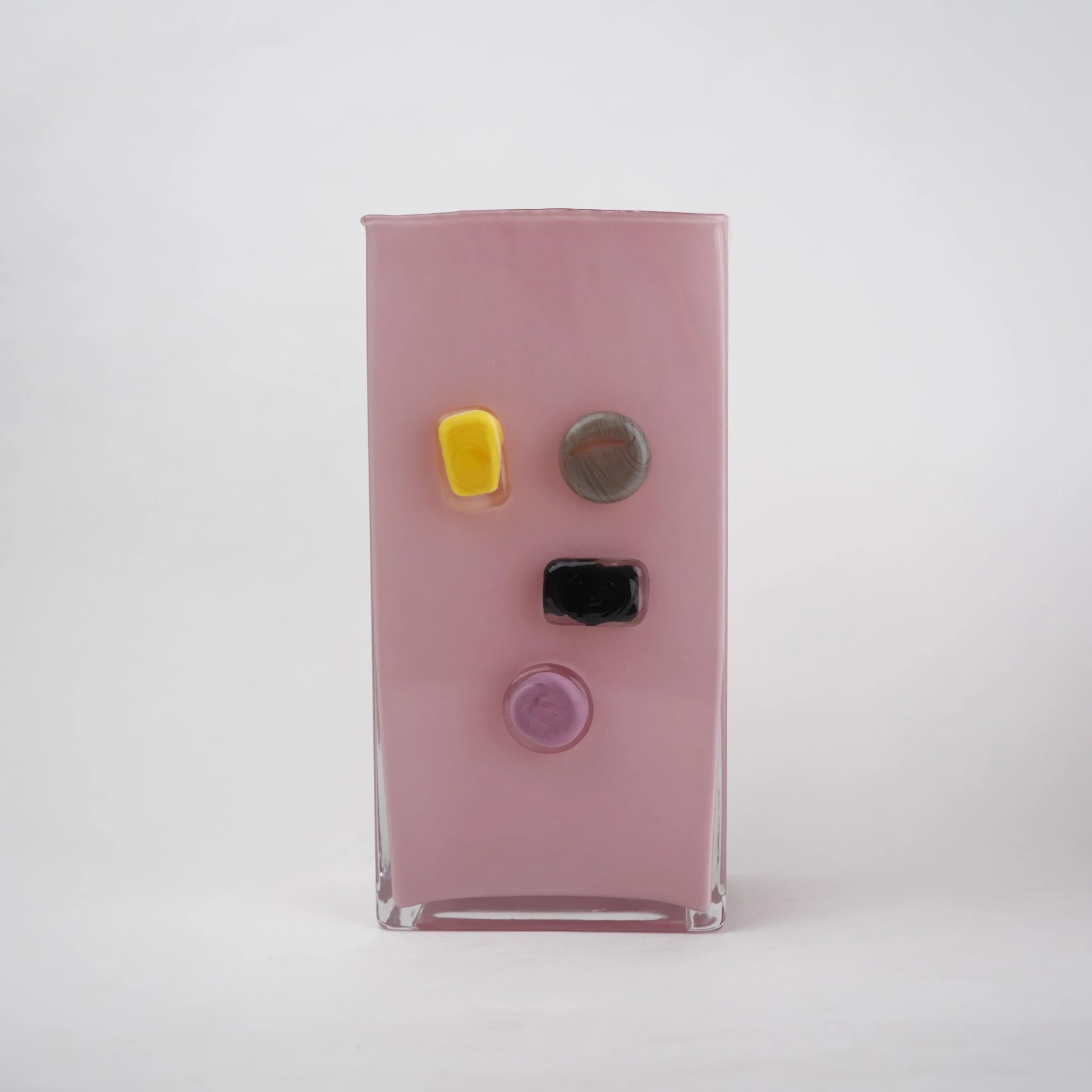 Pink art glass vase with embedded multicolor accents and wide rectangular form.