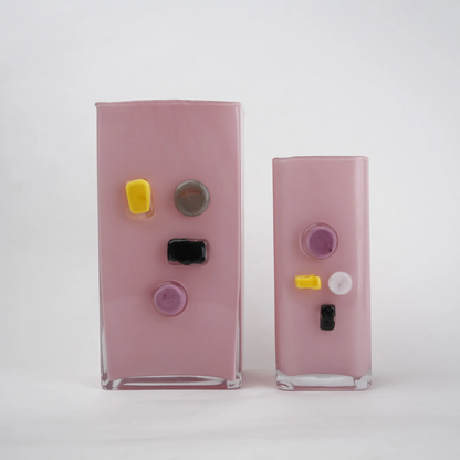 Pink art glass vase with embedded multicolor accents and wide rectangular form.
