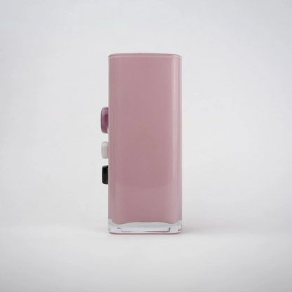 Pink art glass vase with embedded multicolor accents and wide rectangular form.