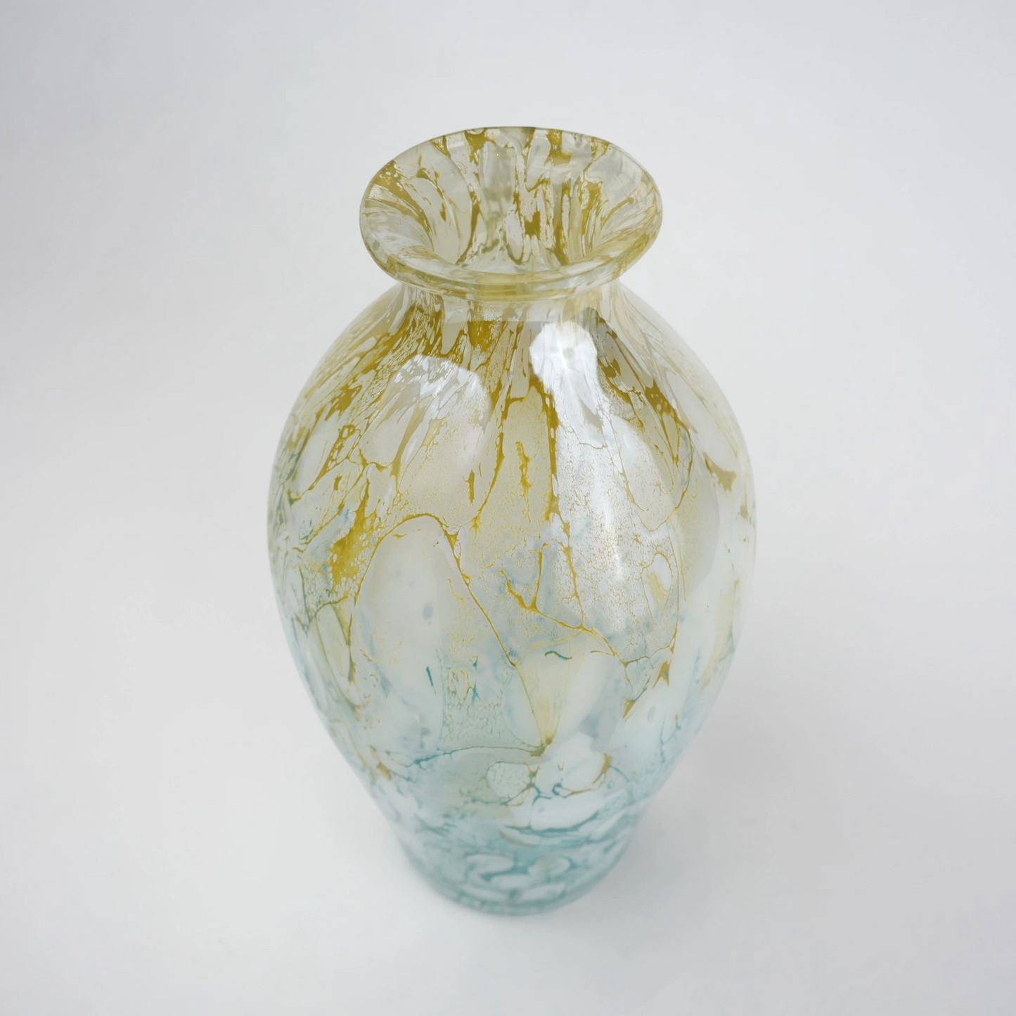 Rounded decorative vase with a narrow neck and marbled finish.