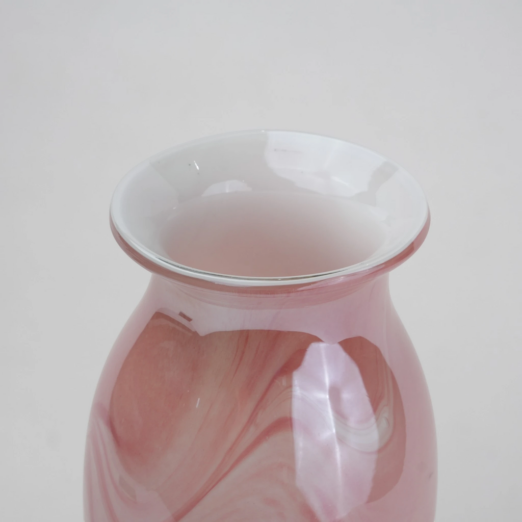 Pink marble glass vase with elongated silhouette and smooth finish.