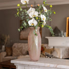 Pink marble glass vase with elongated silhouette and smooth finish.
