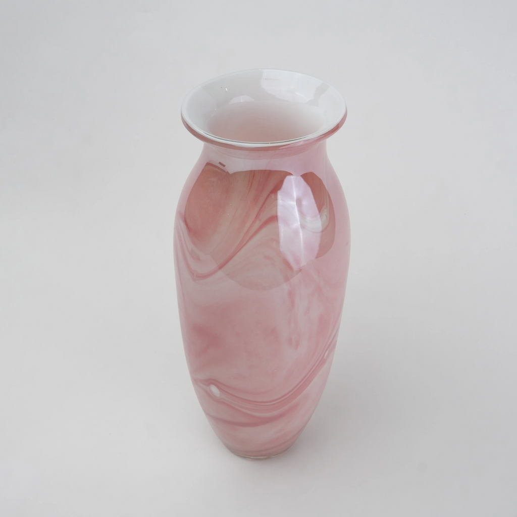 Pink marble glass vase with elongated silhouette and smooth finish.
