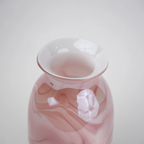 Pink marble glass vase with elongated silhouette and smooth finish.