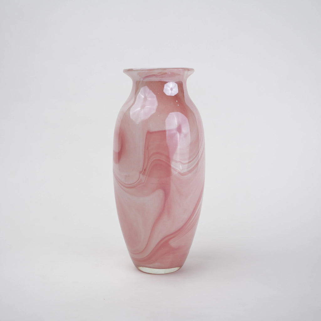 Pink marble glass vase with elongated silhouette and smooth finish.