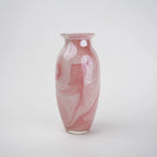 Pink marble glass vase with elongated silhouette and smooth finish.