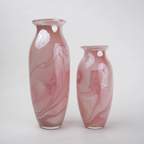 Pink marble glass vase with elongated silhouette and smooth finish.