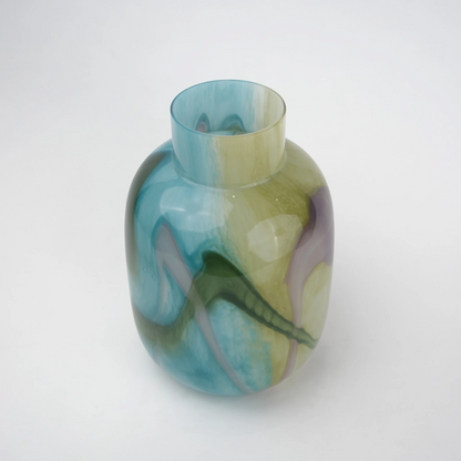 Blue marble effect glass vase with a smooth glossy finish, featuring a rounded body and short cylindrical neck, designed as a modern decorative piece for home decor styling.