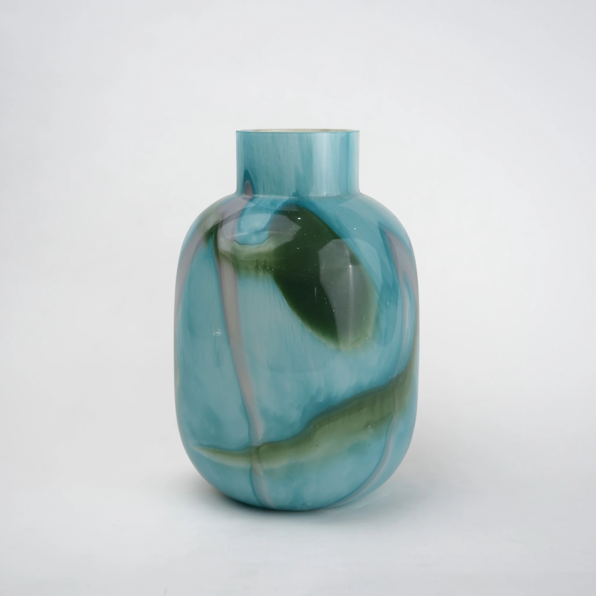 Blue marble effect glass vase with a smooth glossy finish, featuring a rounded body and short cylindrical neck, designed as a modern decorative piece for home decor styling.