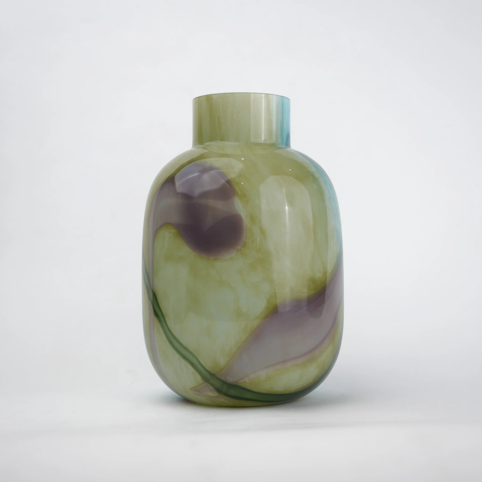 Blue marble effect glass vase with a smooth glossy finish, featuring a rounded body and short cylindrical neck, designed as a modern decorative piece for home decor styling.