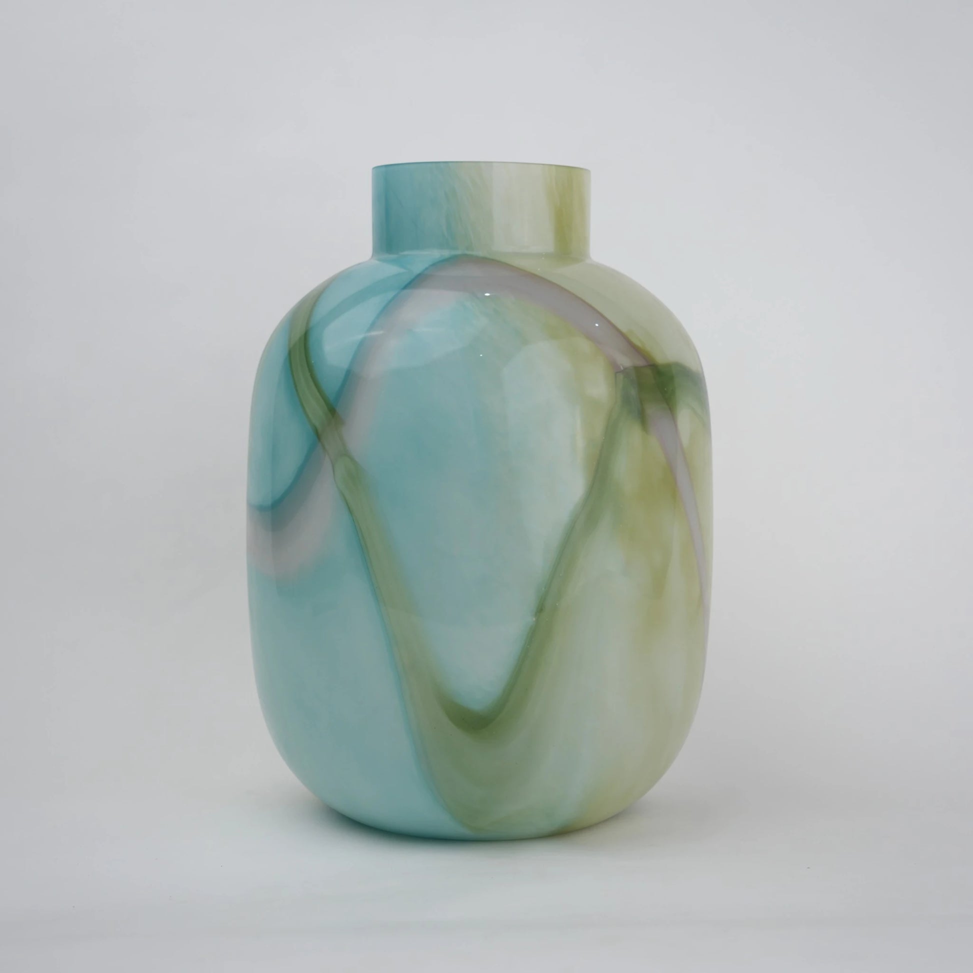 Blue marble effect glass vase with a smooth glossy finish, featuring a rounded body and short cylindrical neck, designed as a modern decorative piece for home decor styling.