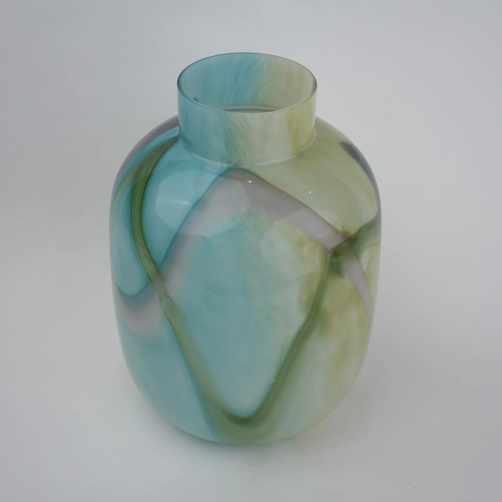 Blue marble effect glass vase with a smooth glossy finish, featuring a rounded body and short cylindrical neck, designed as a modern decorative piece for home decor styling.