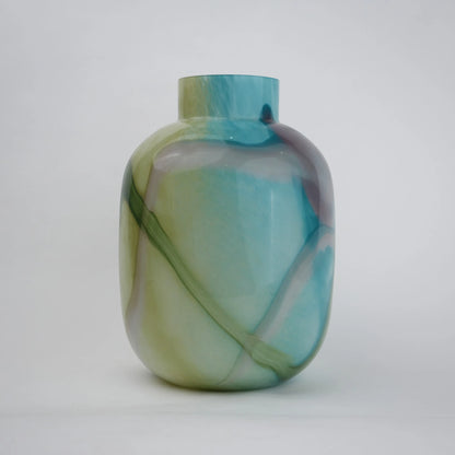Blue marble effect glass vase with a smooth glossy finish, featuring a rounded body and short cylindrical neck, designed as a modern decorative piece for home decor styling.