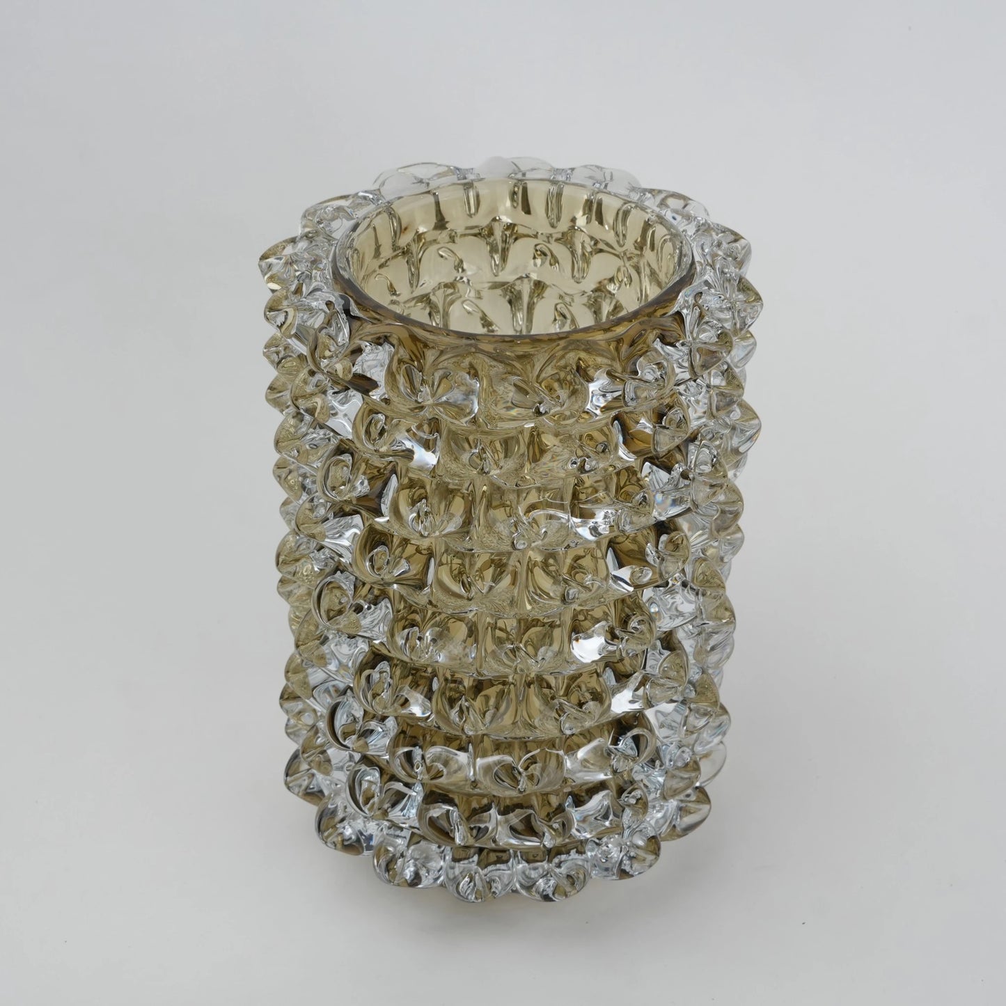 Decorative glass vase with textured pattern on a white background