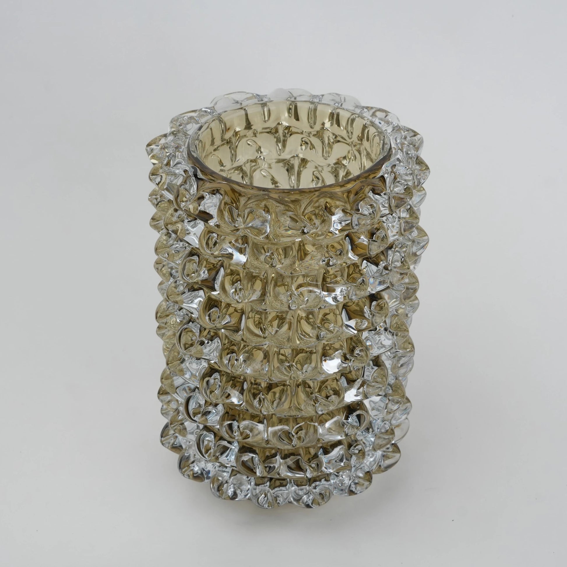 Decorative glass vase with textured pattern on a white background