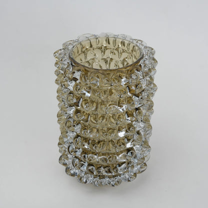 Decorative glass vase with textured pattern on a white background