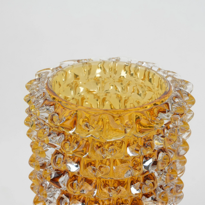Textured glass vase with a rough matte finish, featuring an organic rounded shape and distressed surface, designed as a modern decorative piece for home interiors and styling.