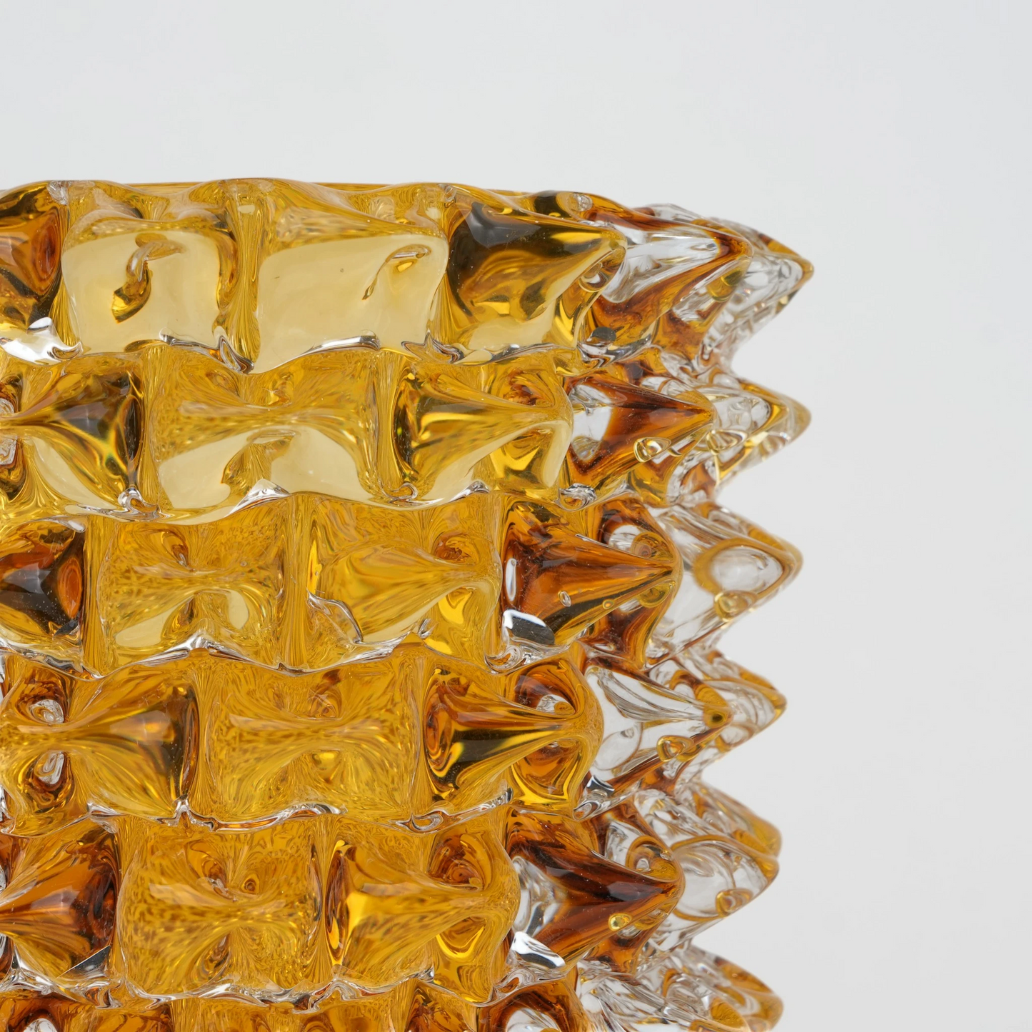 Textured glass vase with a rough matte finish, featuring an organic rounded shape and distressed surface, designed as a modern decorative piece for home interiors and styling.