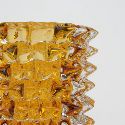Textured glass vase with a rough matte finish, featuring an organic rounded shape and distressed surface, designed as a modern decorative piece for home interiors and styling.