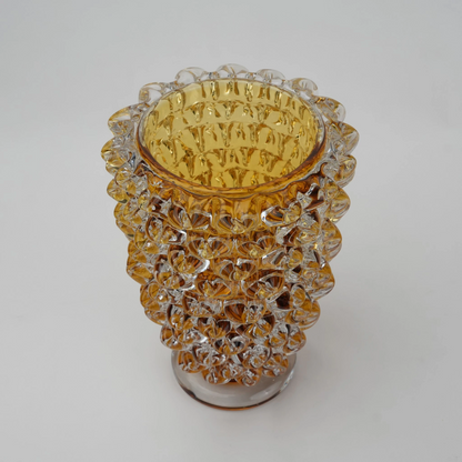 Textured glass vase with a rough matte finish, featuring an organic rounded shape and distressed surface, designed as a modern decorative piece for home interiors and styling.