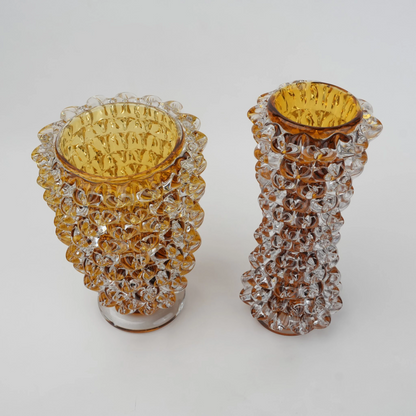 Textured glass vase with a rough matte finish, featuring an organic rounded shape and distressed surface, designed as a modern decorative piece for home interiors and styling.
