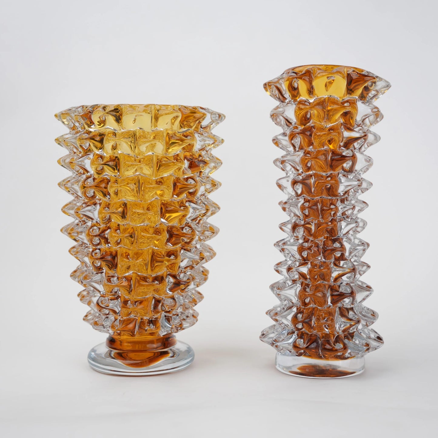 Textured glass vase with a rough matte finish, featuring an organic rounded shape and distressed surface, designed as a modern decorative piece for home interiors and styling.