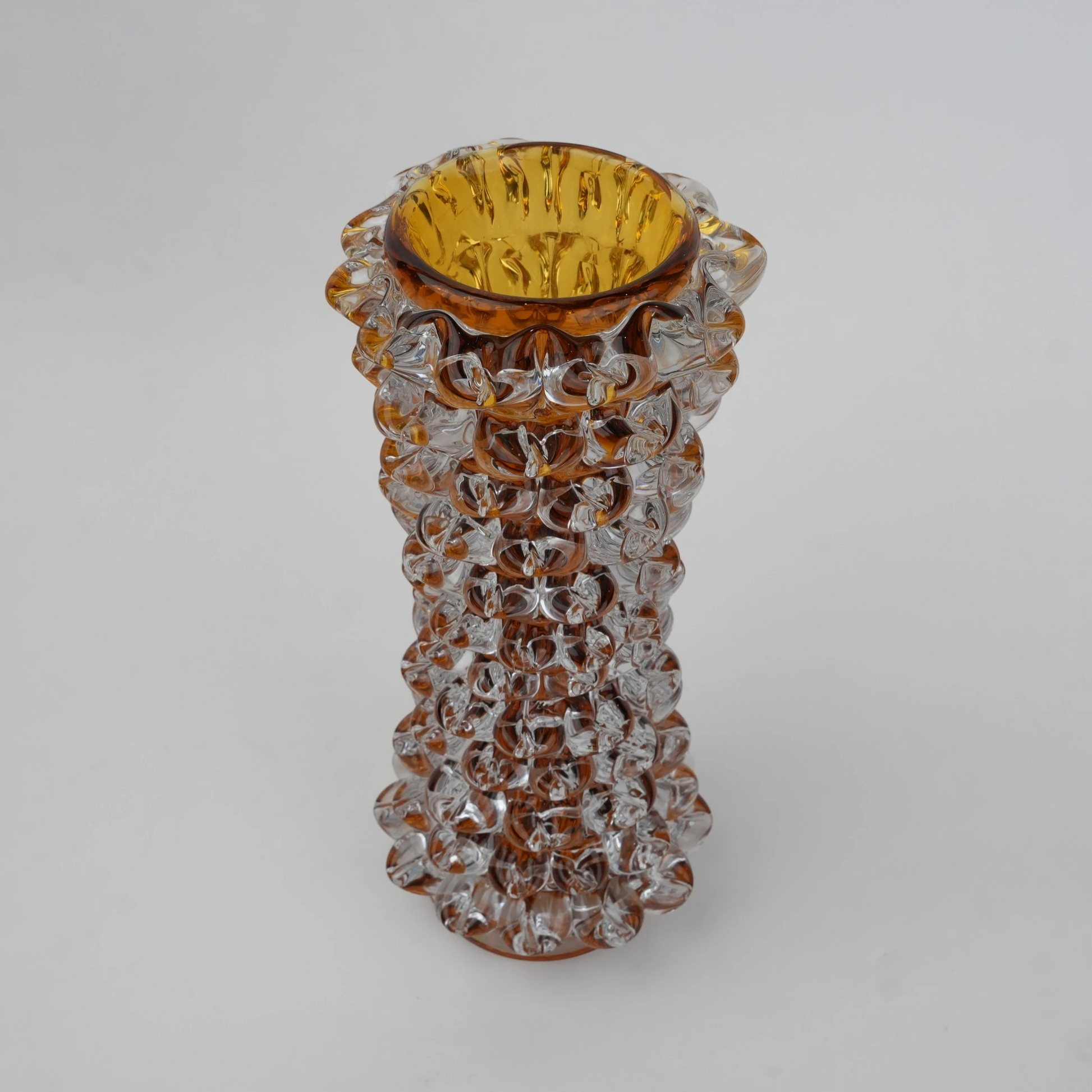Tall glass vase with a textured distressed finish, featuring a tapered body and narrow neck, designed as a modern decorative piece for home interiors