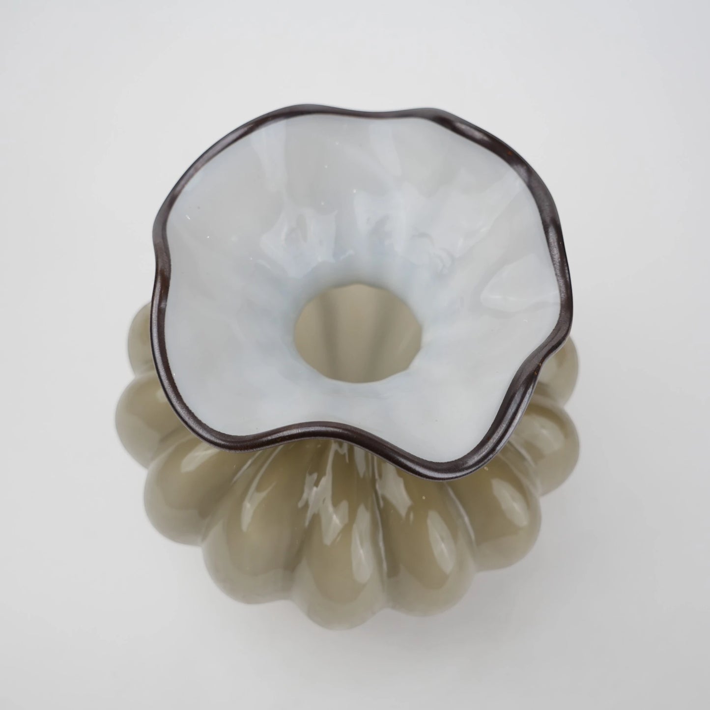 Ribbed glass vase with a smoky beige tint, featuring a rounded bulb shape and a wavy flared rim, designed as a modern decorative piece for home decor styling.