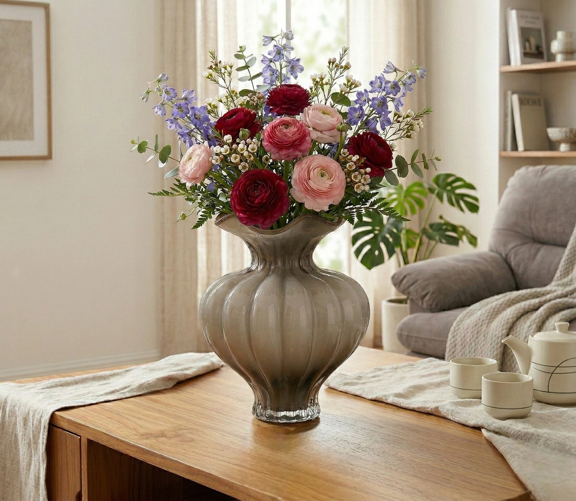 Ribbed glass vase with a smoky beige tint, featuring a rounded bulb shape and a wavy flared rim, designed as a modern decorative piece for home decor styling.