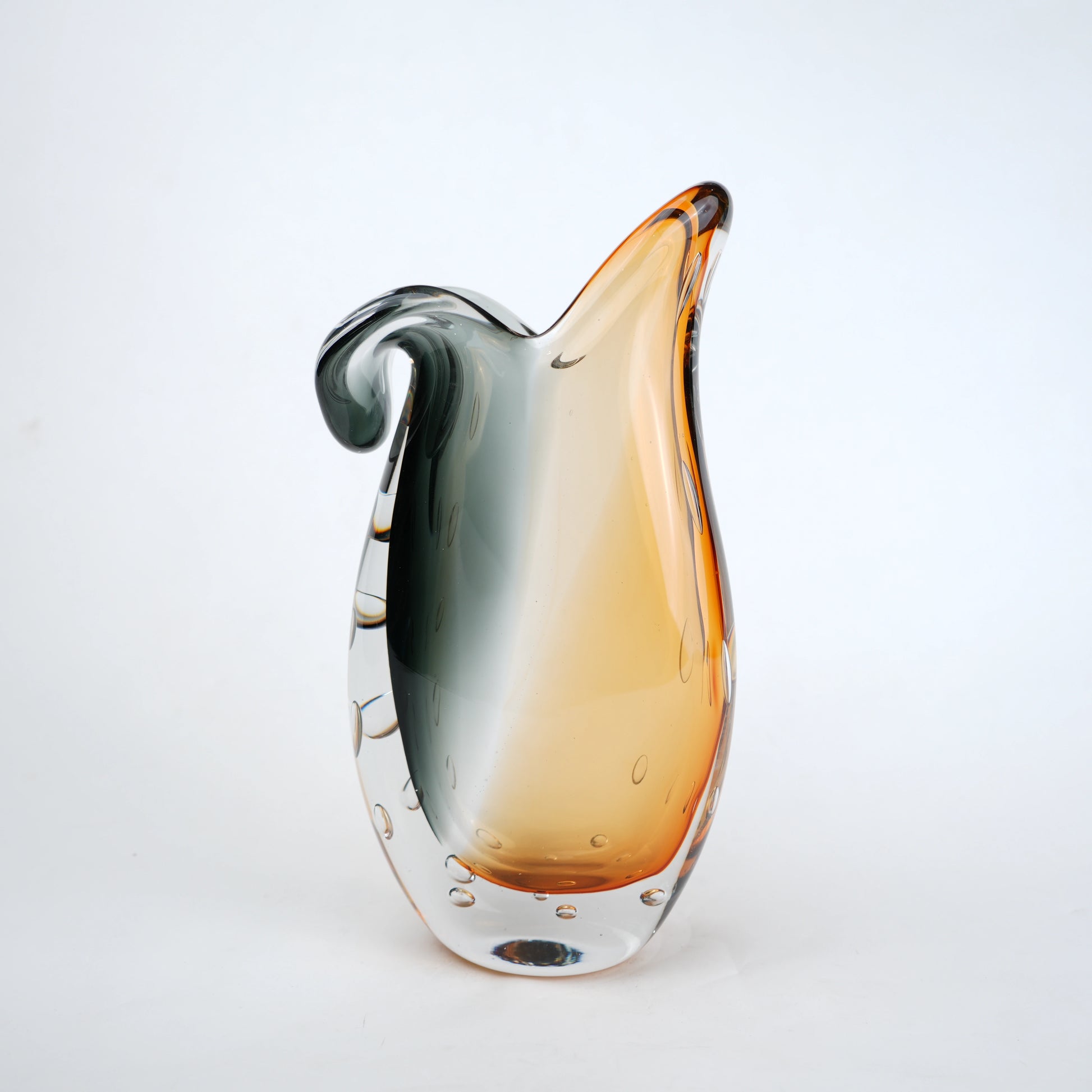 Glass vase with gradient color from gray to orange on a white background