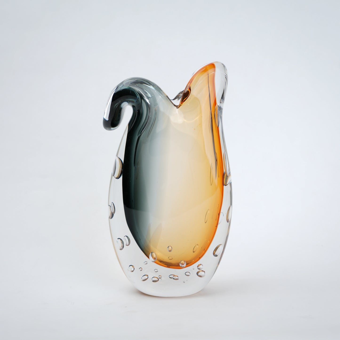 Glass vase with gradient color from gray to orange on a white background
