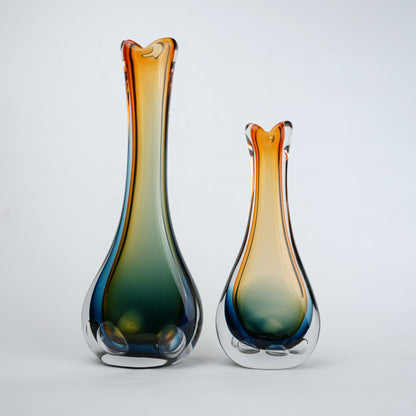 Two glass vases with gradient colors on a white background