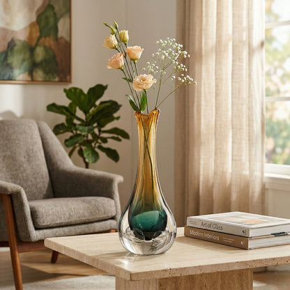 Glass vase with flowers on a coffee table in a living room setting