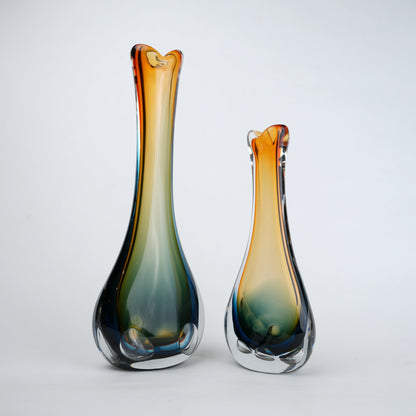 Two glass vases with gradient colors on a white background