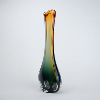 Glass vase with gradient color from brown to green on a white background