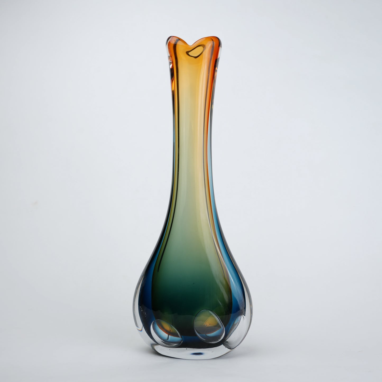 Multicolored glass vase on a light gray background