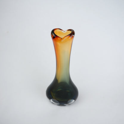 Glass vase with a heart-shaped opening on a white background