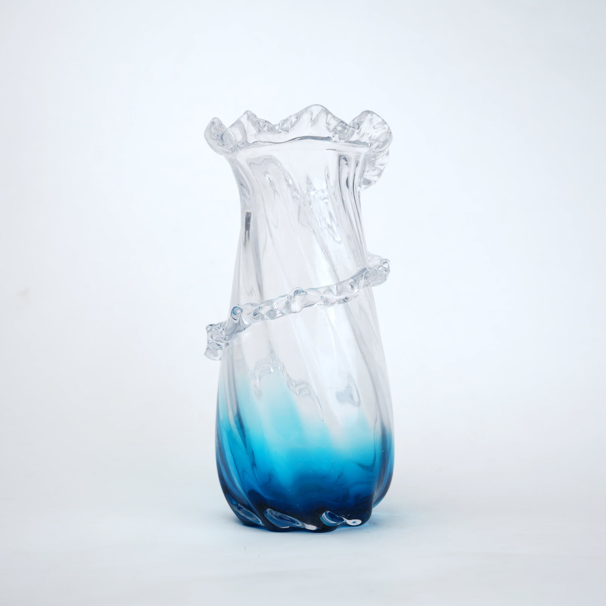 Glass vase with blue gradient on a white background