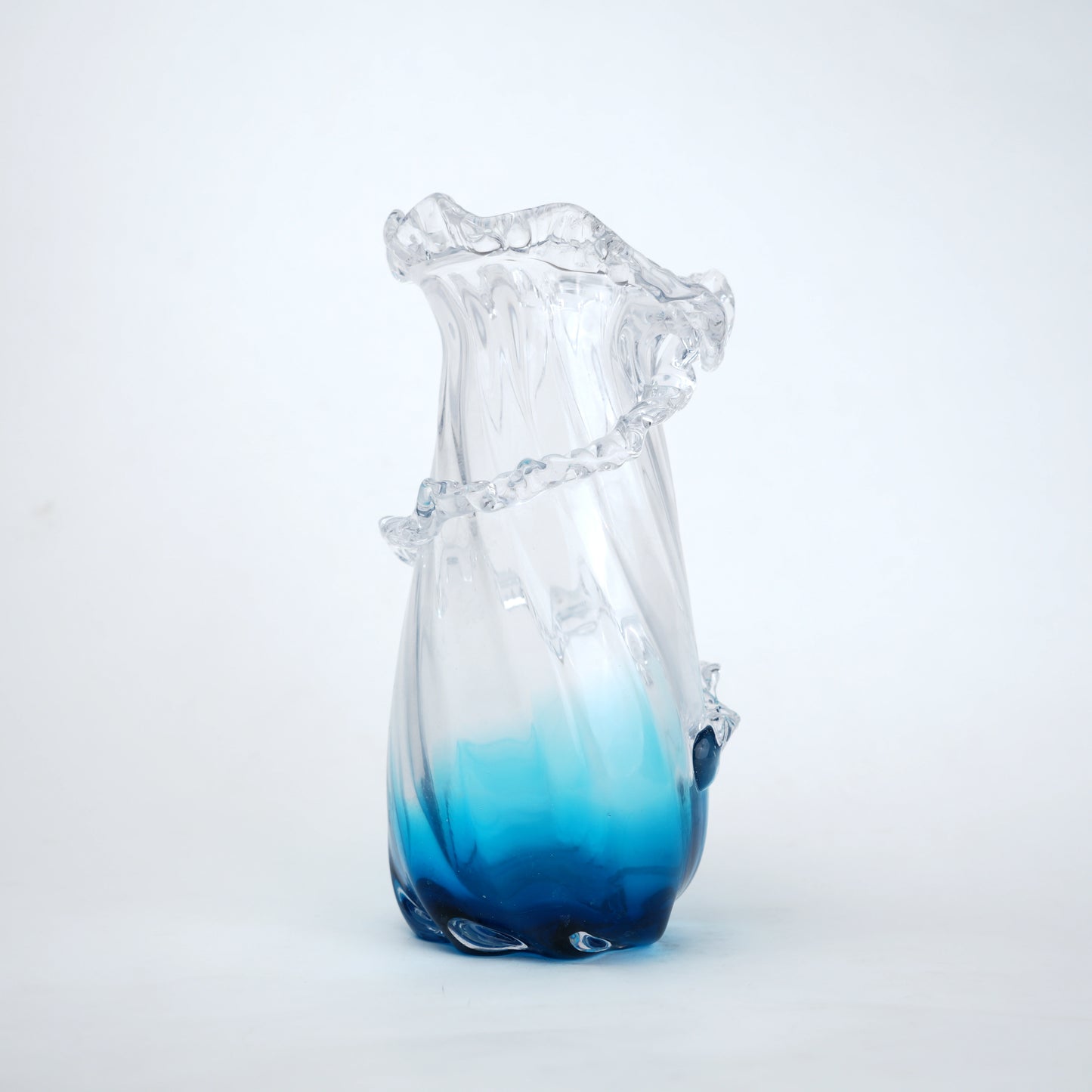 Glass vase with blue gradient on a white background