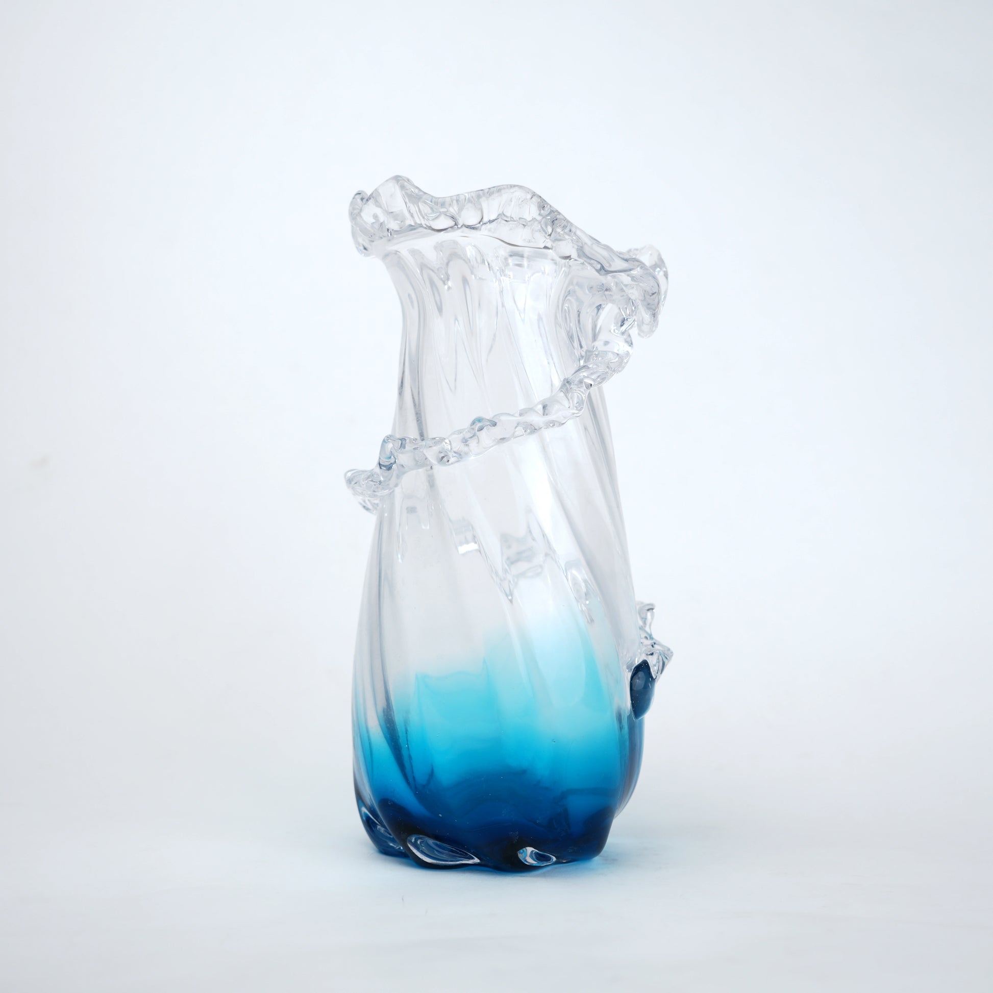 Glass vase with blue gradient on a white background