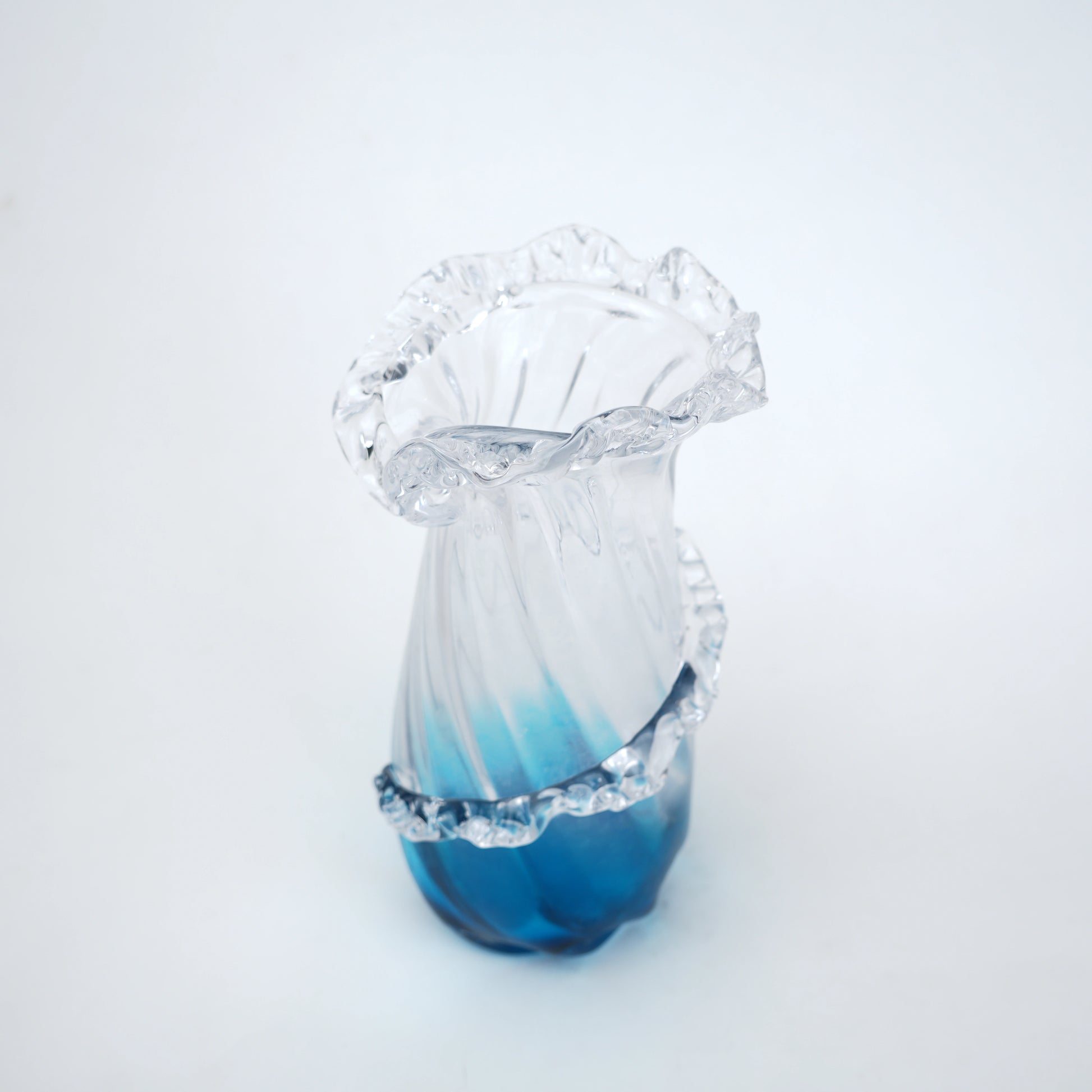 Glass vase with blue gradient on a white background